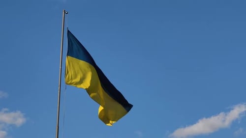 Ukraine Flag Waving Proudly Against a Clear Blue Sky