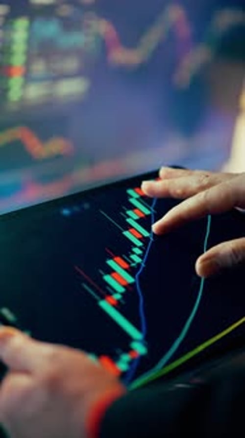 Analyst Examining Stock Data on Tablet and Monitor