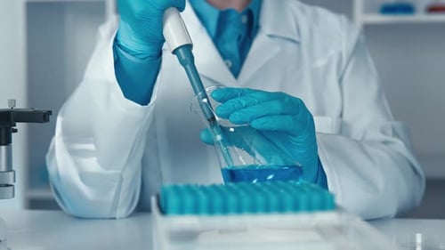 Scientist Using Pipette in Medical Laboratory