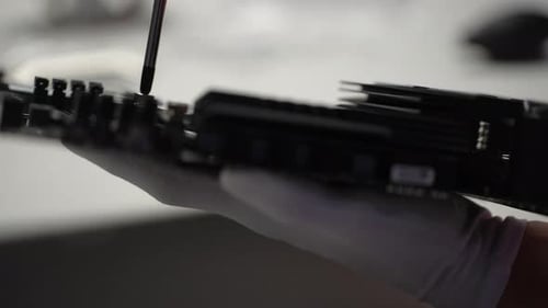 Closeup Side View of Unrecognizable Technician in Gloves Screwing in PC CPU Air Cooling System