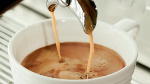 Coffee Pouring into White Mug Close Up