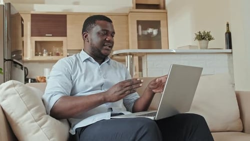 Man On Laptop Having Video Call At Home