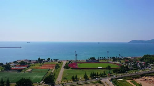 Approaching the beautiful waterscape of Adriatic Sea. Drone footage above the green area