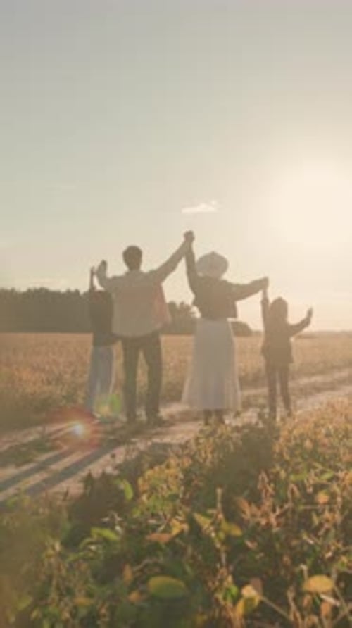 Evening Scene of Family in Rural Landscape Parents and Children Enjoying Peaceful Sunset Walk in