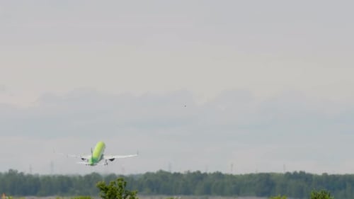 Passenger Airplane Ascending into Overcast Sky