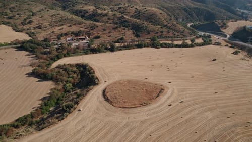Aerial view of harvested crop field, drone view of hay bales in the field