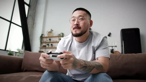Excited Man Playing Video Game at Home