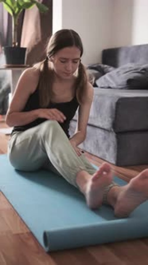 Seated Forward Bend Stretch on Mat Woman Doing Yoga at Home for Flexibility and Healthy Lifestyle