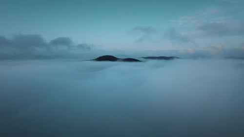 Flying below the magical ocean of blue clouds at evening.