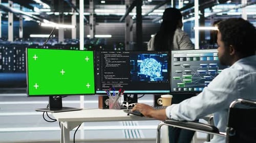 Data Center Admin in Wheelchair Using AI Node Tree Software on Green Screen PC