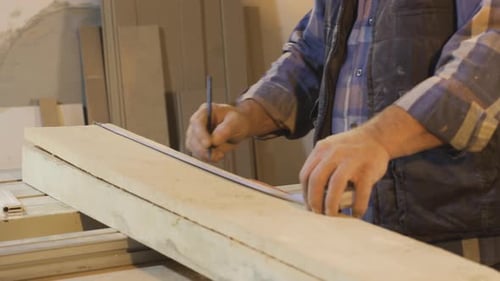 Close-up hands of male carpenter.