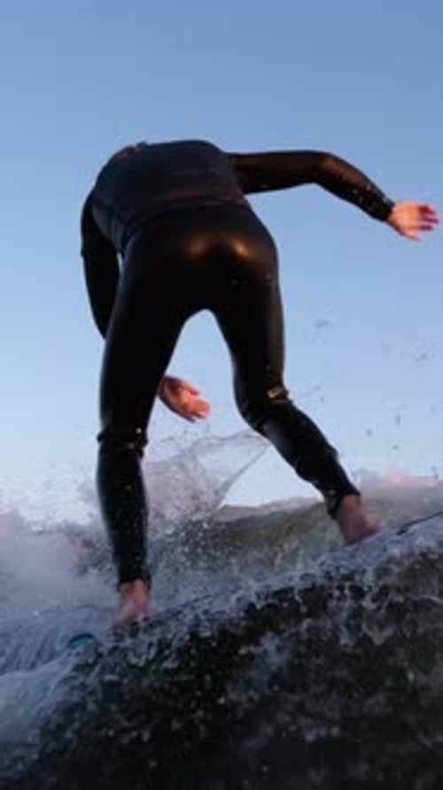 A Surfer Masterfully Riding the Wave at Sunset Capturing the Thrill and Dynamics of Extreme Water