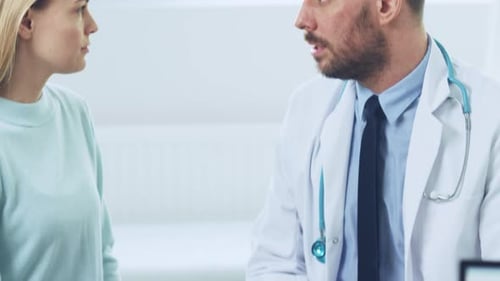 Doctor Consults With Patient in Examination Room