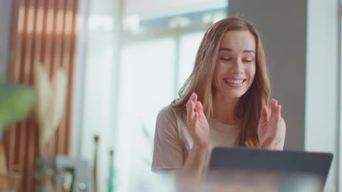 Woman Reacting Positively to Something on Laptop