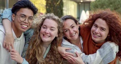 Happy Friends Smiling and Embracing Each Other