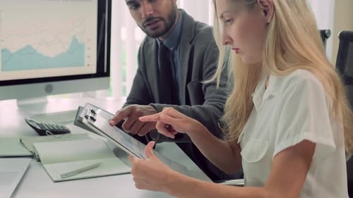 Office Workers Sitting at Table with Tablets while Preparing for Conference
