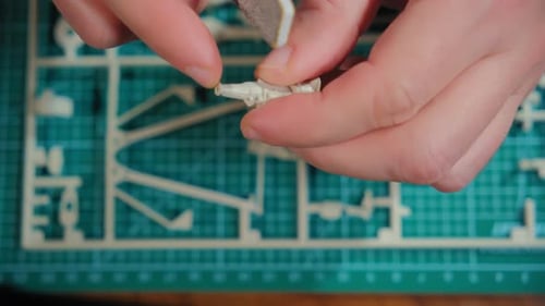 Man Assembler Plastic Model at Table Close Up Footage of Hands