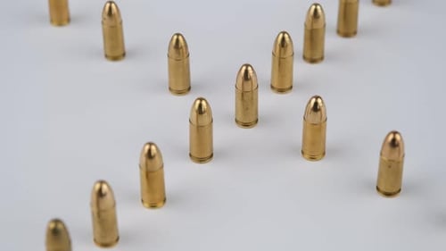 Gold Bullets Arranged on White Background