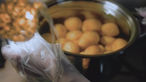 Adding Potatoes to a Pot of Water