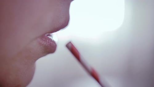 Extreme Close Up of Mouth Drinking from Straw