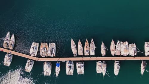 Aerial Top View of Yachts and Boats Docked Along Marina Pier