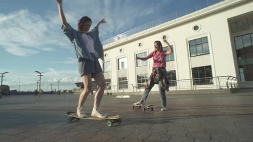 Young Women Skateboarding in Urban Environment