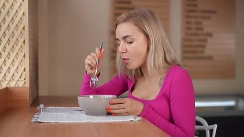 Side View Young Caucasian Woman Eating Tasty Dumplings in Slow Motion with Satisfied Facial