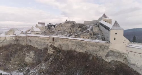 Aerial orbit around Rasnov Citadel in Romania, during winter time.