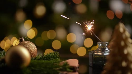 Festive Sparkler Ignites Amidst Golden Holiday Lights