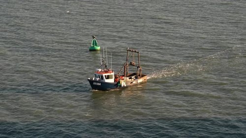 Fishing Boat Moving on the Sea on a Sunny Day