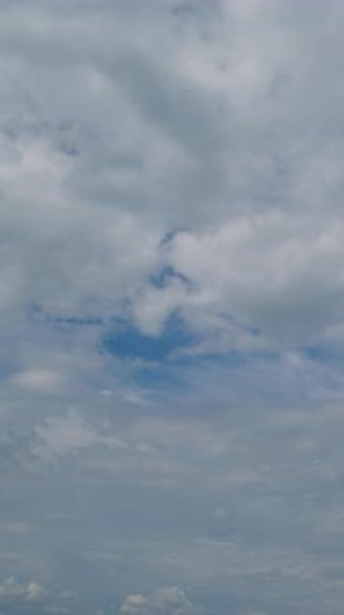 Aerial View of White Clouds Drifting Across Blue Sky