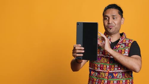 Radiant Man Saluting Friend Over Online Videocall Studio Background