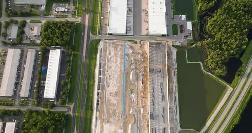 Construction Site of Logistic Center with Assembling of Concrete and Metal Frame Walls Aerial View