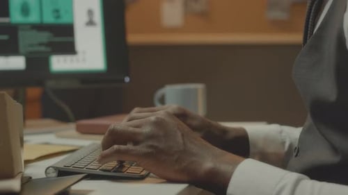 Detective Agent Typing on Keyboard while Working in Office