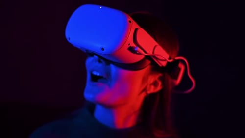 Woman Using Virtual Reality Headset in Dark Room