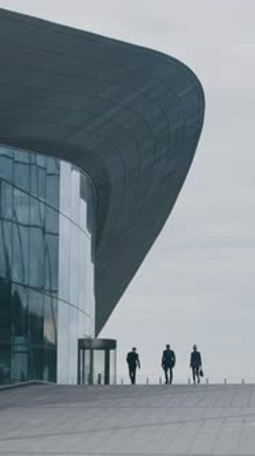 Vertical of Employees Going towards Glass Office Building in City