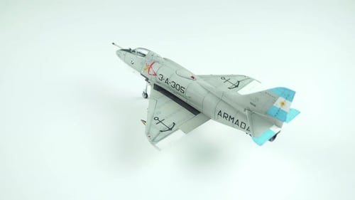 Model Airplane Rotating on White Surface