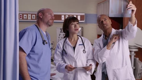 Medical professionals collaborating over x-rays in a modern hospital setting