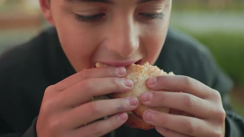 Close Up Boy Savoring Burger Outdoors