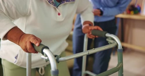 Senior Adult Using Walker Indoors with Assistance