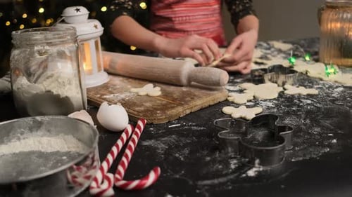 Girl Cutting Gingerbread Men From Dough