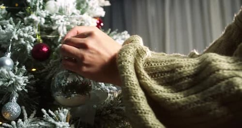 Decorating Christmas Tree with Holiday Ornaments