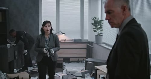 Police Investigators Examine Crime Scene in Office