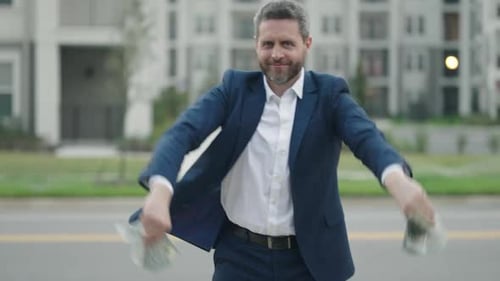 Man Holding Money and Dancing Outdoors