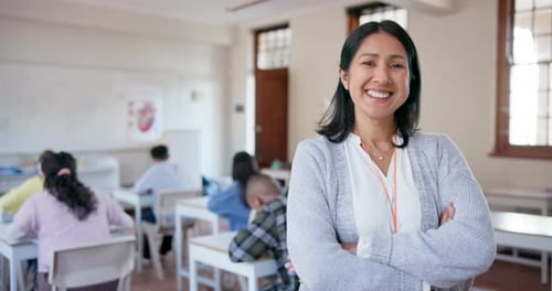 Smile, arms crossed and a woman teacher in her classroom for education, learning or development
