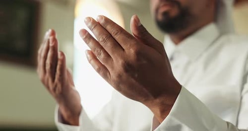 Hands, praying and muslim man in mosque for worship, peace or spiritual gratitude with religion