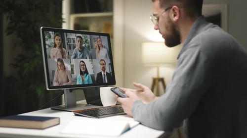 Man Teleconferencing at Home Uses Smart Phone