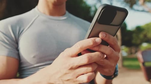 Close-up of the hands of an unrecognizable young man using a mobile phone