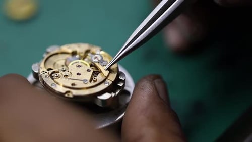close up footage of a craftsman delicately repairing a vintage watch