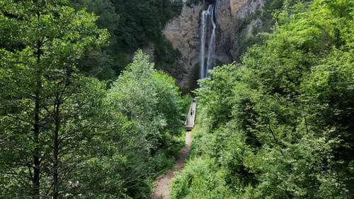 Aerial View Of A Beautiful Waterfall Surrounded By Forest